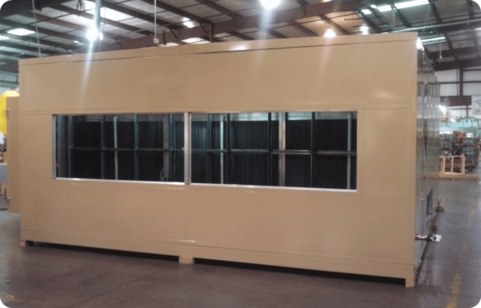 Modular office unit in industrial warehouse.