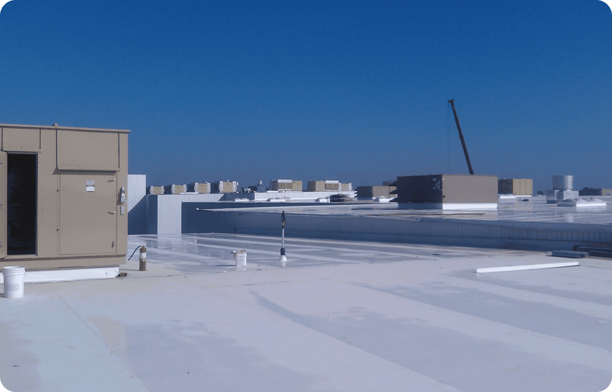 Rooftop with machinery and clear blue sky.