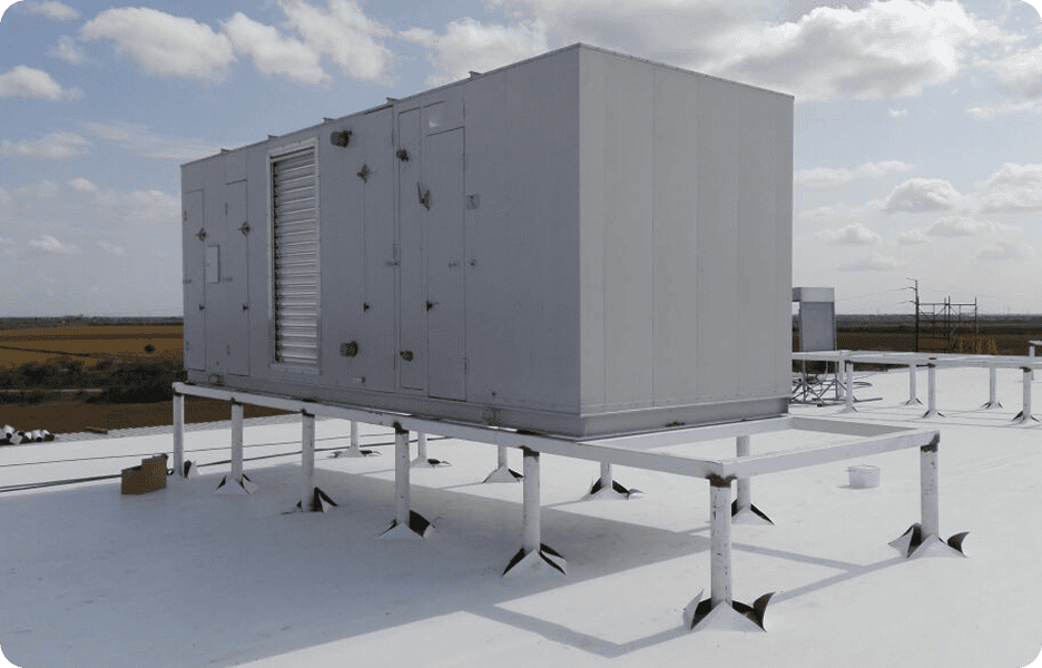 Rooftop HVAC unit under cloudy sky.
