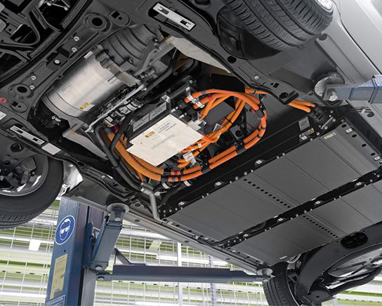 Underside of electric vehicle on lift.